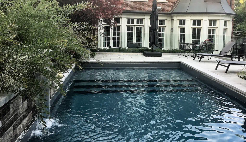 The Pinnacle swimming pool design by Leisure Pools: shown in ebony blue color